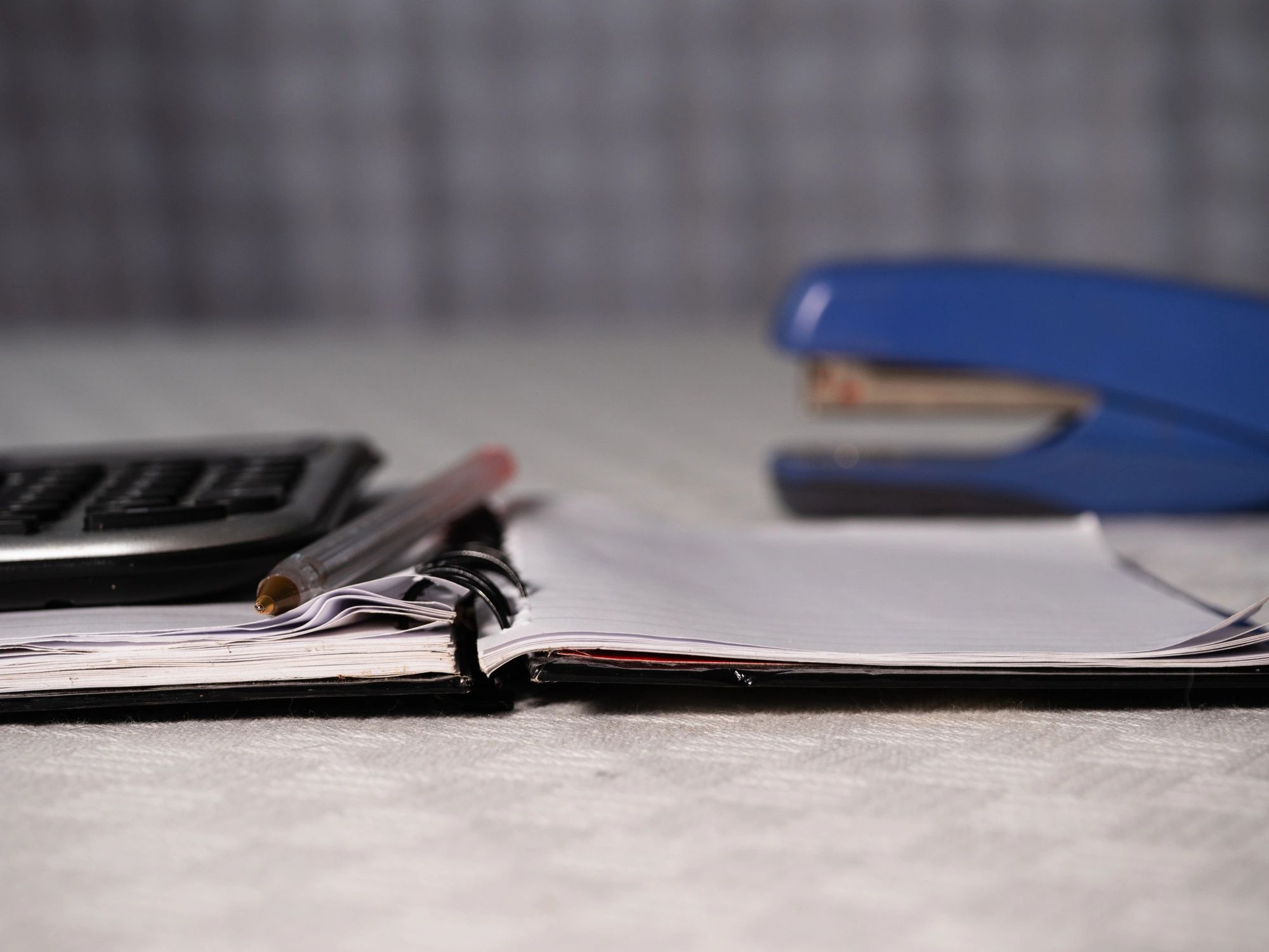 Financial documents and calculator on office desk